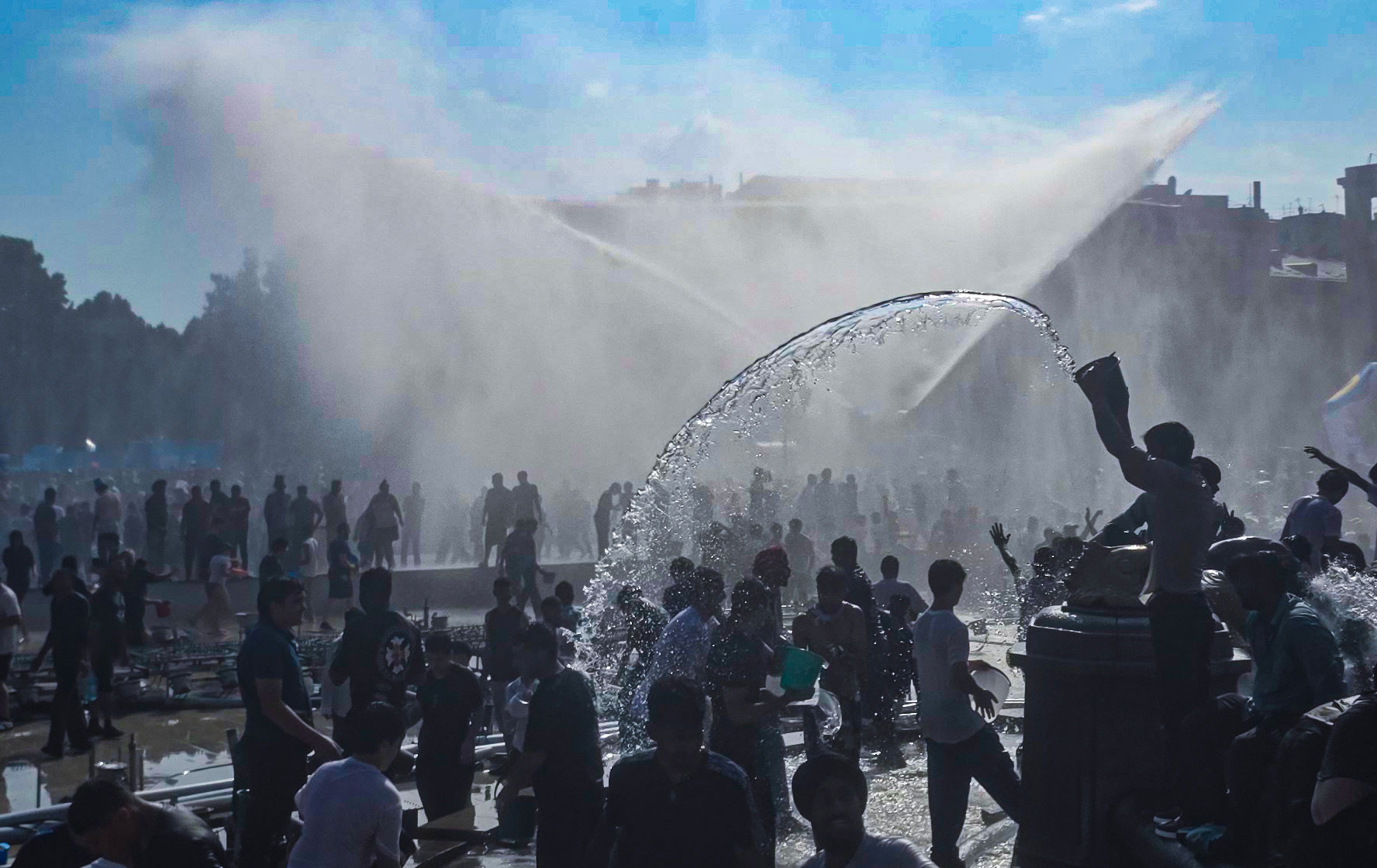 Massive water fight at Republic Square during Vardavar with the History Museum in the background